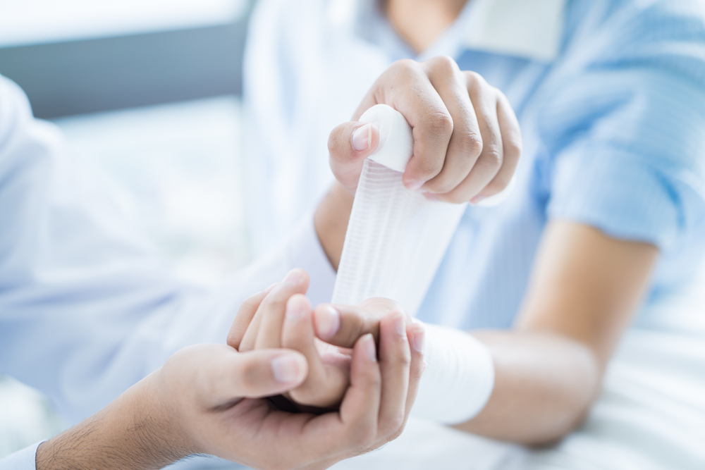 Close-up,Doctor,Is,Bandaging,Upper,Limb,Of,Patient.