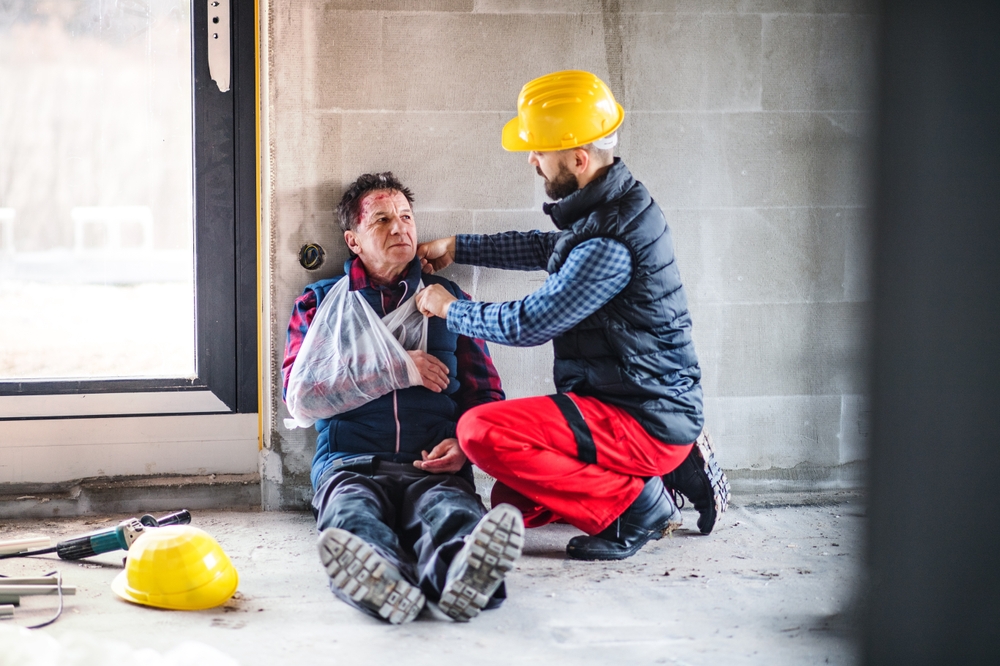 Colleague,Giving,First,Aid,To,Injured,Worker,,In,Pain,After